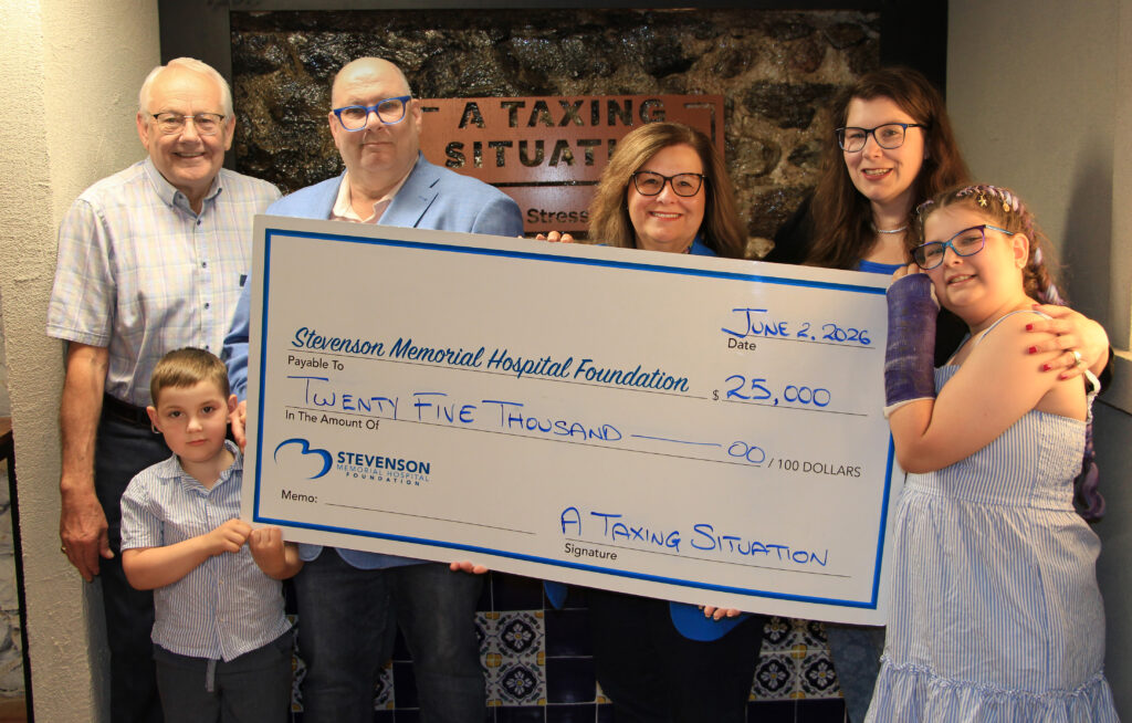Cheque presentation with A Taxing Situation Owner and Family, list of people to follow